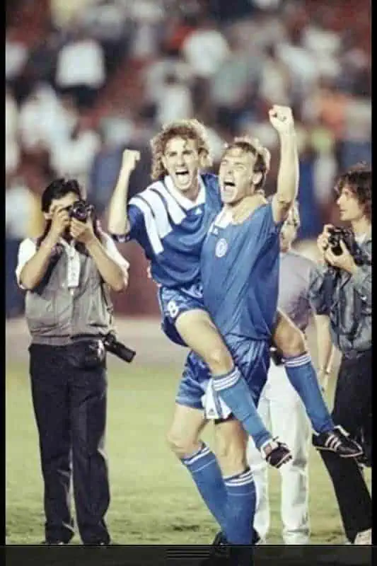 767516002600062983408921564603386981253120n River Islands Two soccer players in blue celebrate a goal on the field as photographers capture the moment