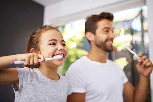 BackToSchoolMorningRoutinesFatherDaughterBrushingTeeth1geo River Islands girl and father brush teeth