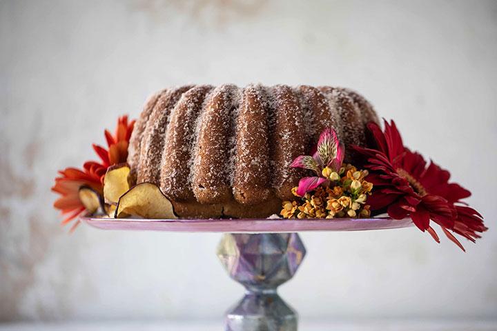 cake on platform surrounded by flowers
