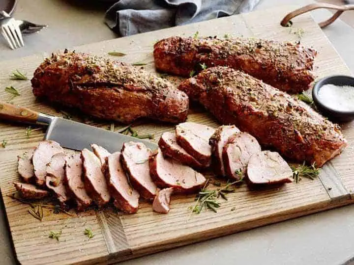 RIBlogHolidayRecipes2022123geo River Islands pork tenderloin on a wood cutting board
