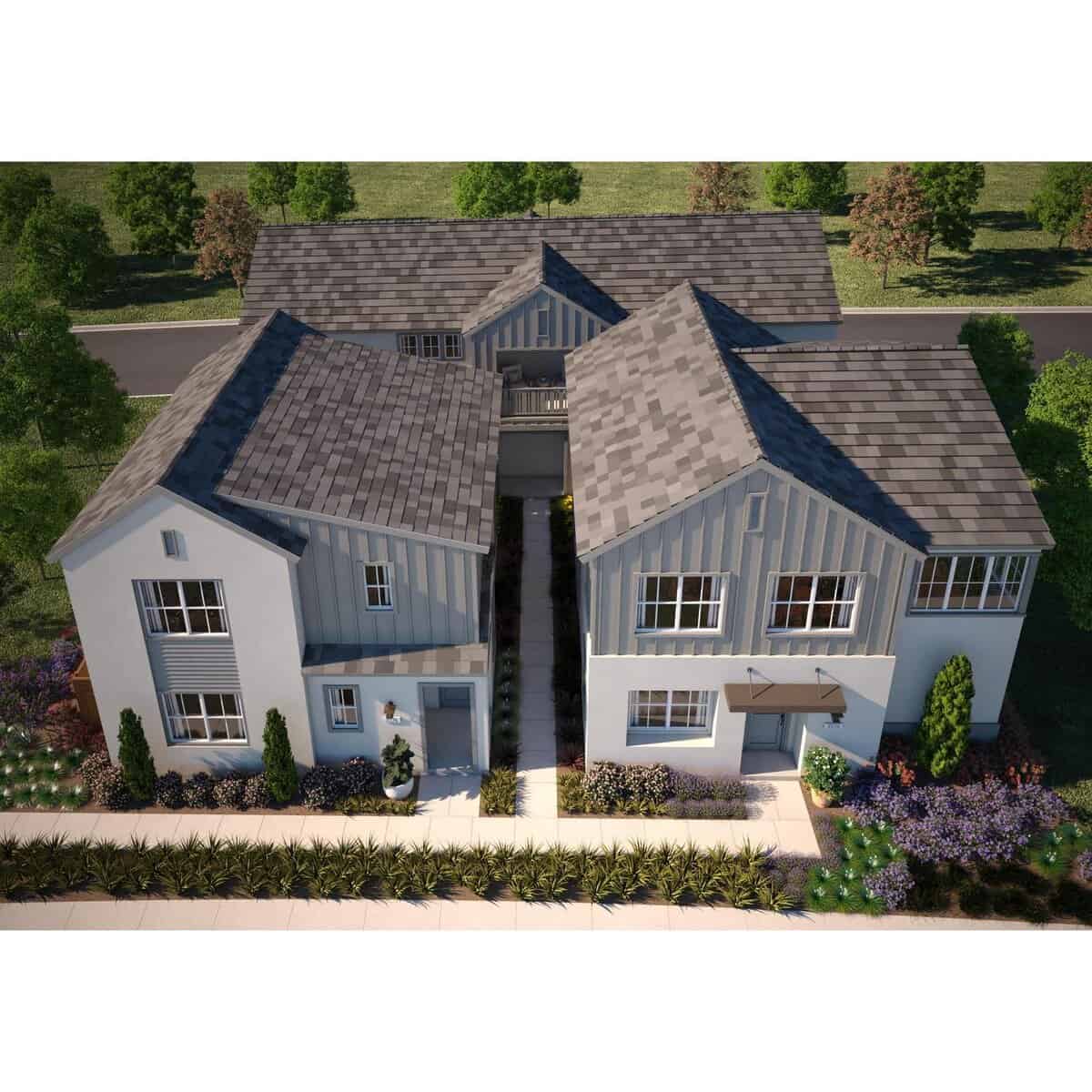 Aerial view of a two wing townhouse complex with a gray gabled roof and landscaped front garden