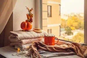 RIBlogFallDecor20230926PumpkinSpice720 River Islands pile of cozy blankets with leaves and pumpkins 3780226789590045 12132193629810645