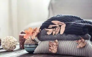 Tri Pointe Homes River Islands pile of cozy blankets with leaves 3780226789590045 12132193629810645