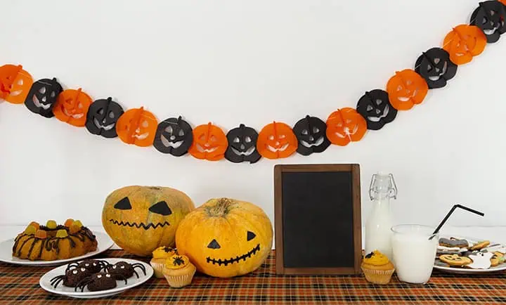 720frontviewcutehalloweenconceptwithcopyspace River Islands table with halloween banner pumpkins and snacks