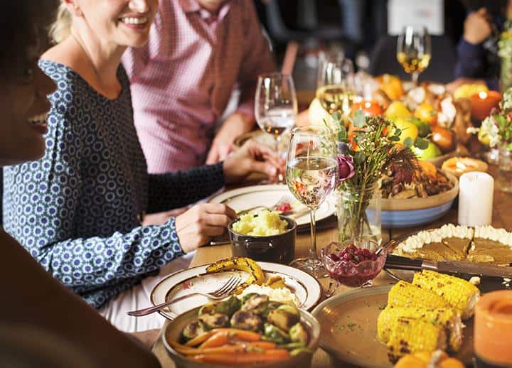 People are celebrating Thanksgiving day River Islands family at thanksgiving table setting