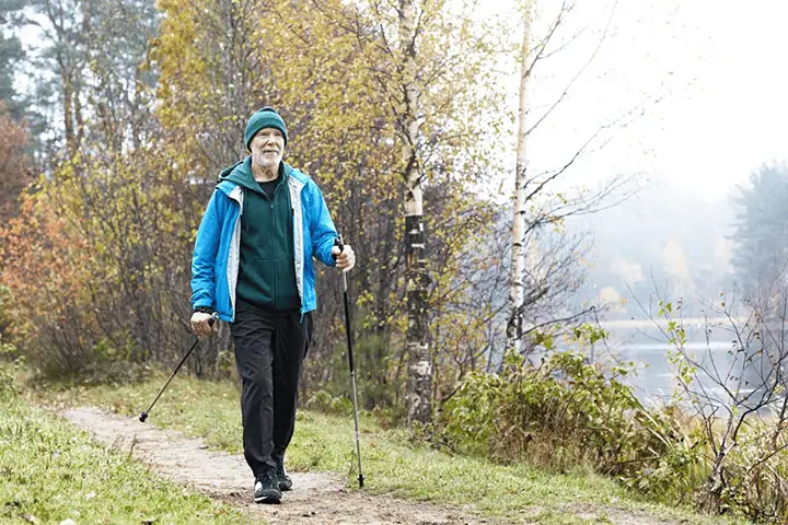 man walking by river in nature