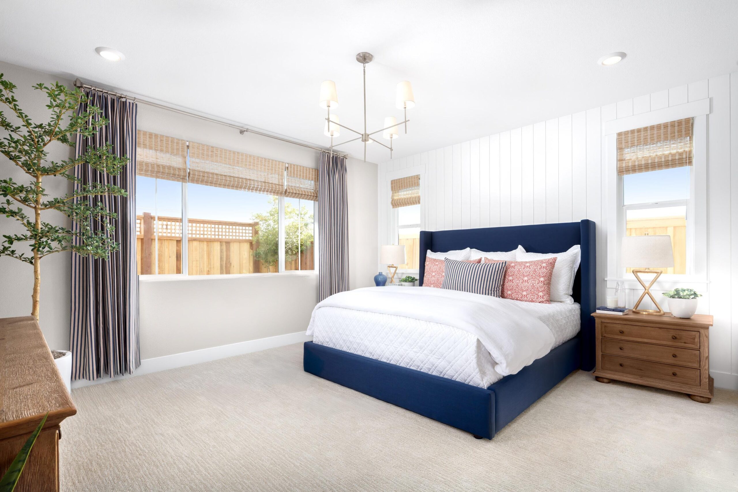 Spacious owner’s suite in Bridgeway Plan 3501 at River Islands, featuring a large window, stylish bedframe, and neutral-toned furnishings.