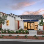 Exterior of Bridgeway Plan 3501 at River Islands by New Home Company, showcasing modern two-story home design with landscaped front yard.