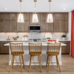 Bridgeway Plan 3502 gourmet kitchen featuring large center island, pendant lighting, stainless steel appliances, and wood cabinetry.