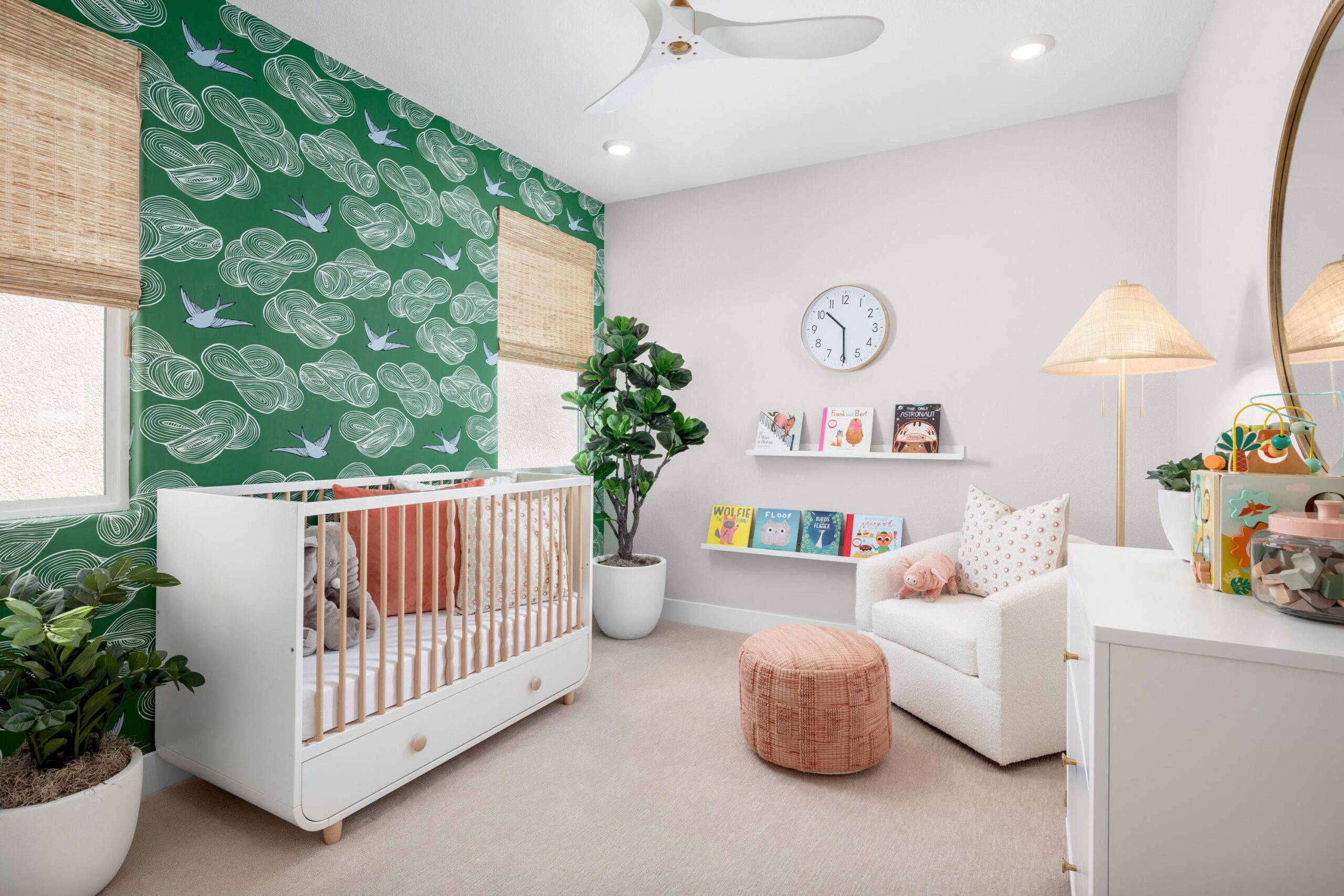 Charming nursery in Bridgeway Plan 3502 with accent wallpaper, white crib, and cozy reading corner.