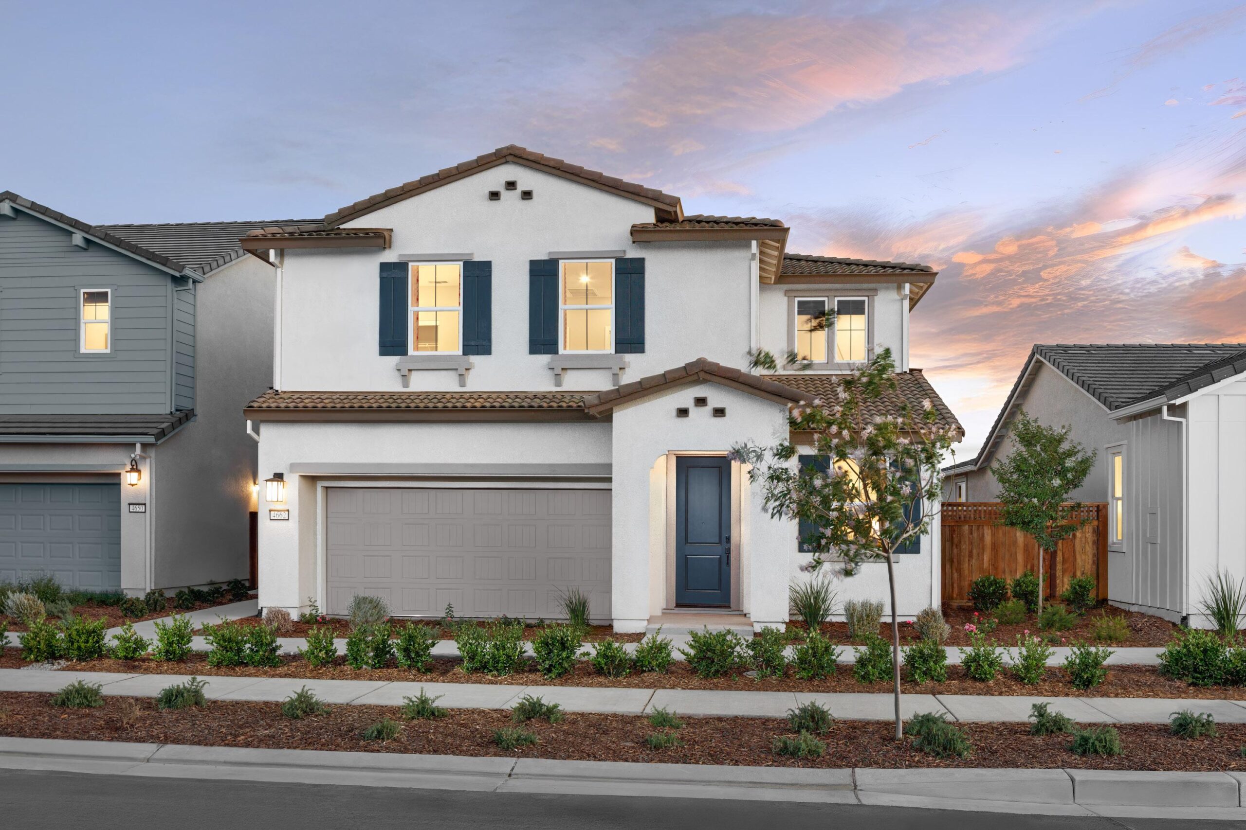 Two-story exterior of Bridgeway Plan 3502 at Bridgeway in River Islands with modern design, attached garage, and landscaped front yard.