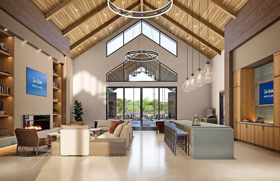 Interior of the Lakeview Club at Del Webb River Islands featuring vaulted wood ceilings, a lounge area with fireplace, and a large community kitchen.