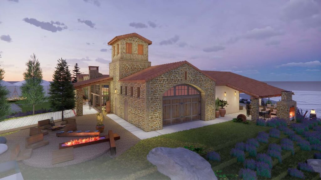 Stone villa with red tiled roof and tower set along a coastline featuring a lit outdoor fire pit and lounge area at dusksunset